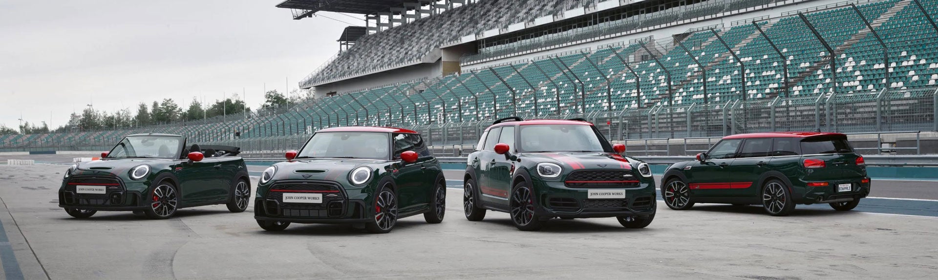 Family of four MINI John Cooper Works models parked on a race track. | MINIDemo3 in Derwood MD
